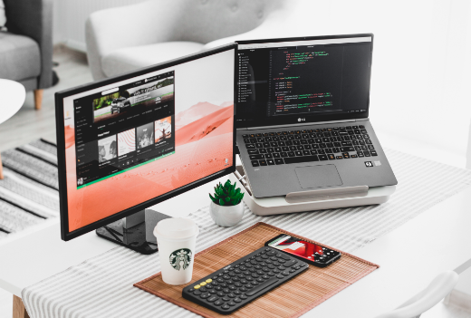 Image of a desk with laptop and monitor